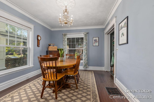 1237 Wealthy St SE, Grand Rapids, MI 49506 - dining room with a chandelier, wood finished floors, baseboards, and crown molding