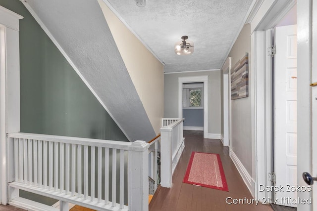 1237 Wealthy St SE, Grand Rapids, MI 49506 - hallway featuring a textured ceiling, an upstairs landing, wood finished floors, ornamental molding, and baseboards
