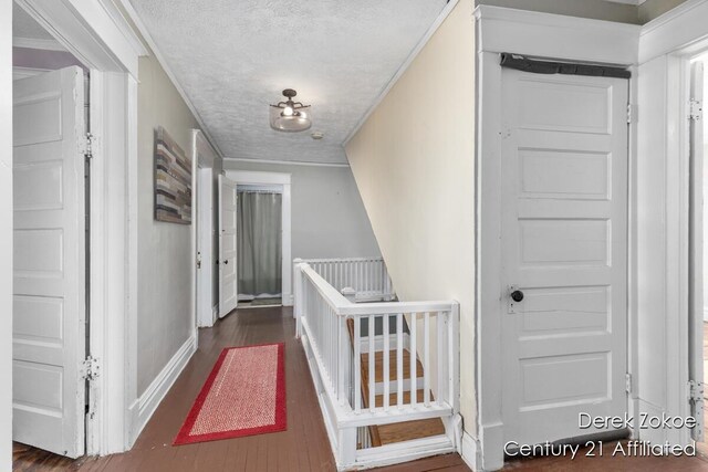 1237 Wealthy St SE, Grand Rapids, MI 49506 - corridor with baseboards, wood finished floors, a textured ceiling, and crown molding