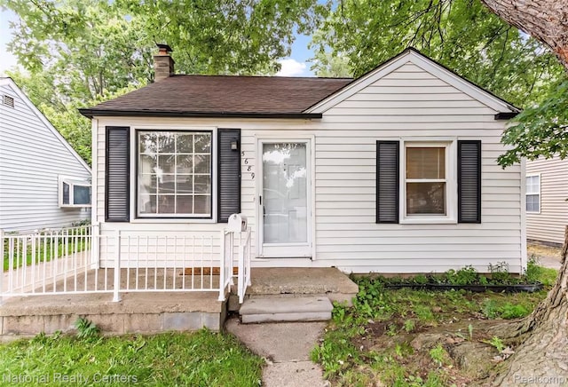 5689 Cornell St, Dearborn Heights, MI 48125 - bungalow featuring a chimney and roof with shingles