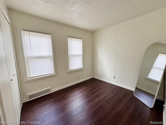 5689 Cornell St, Dearborn Heights, MI 48125 - spare room featuring wood finished floors, a textured ceiling, and baseboards