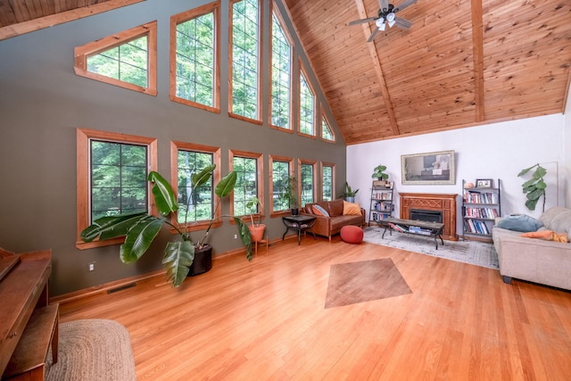 4300 Holton-Duck Lake Rd, Twin Lake, MI 49457 - living room featuring high vaulted ceiling, wood finished floors, wood ceiling with exposed beams, baseboards, and ceiling fan