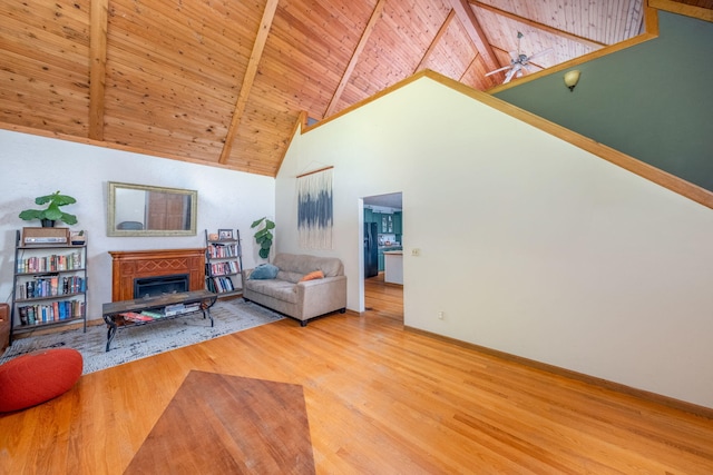 4300 Holton-Duck Lake Rd, Twin Lake, MI 49457 - living area featuring high vaulted ceiling, wood finished floors, a fireplace, wooden ceiling with exposed beams, and ceiling fan