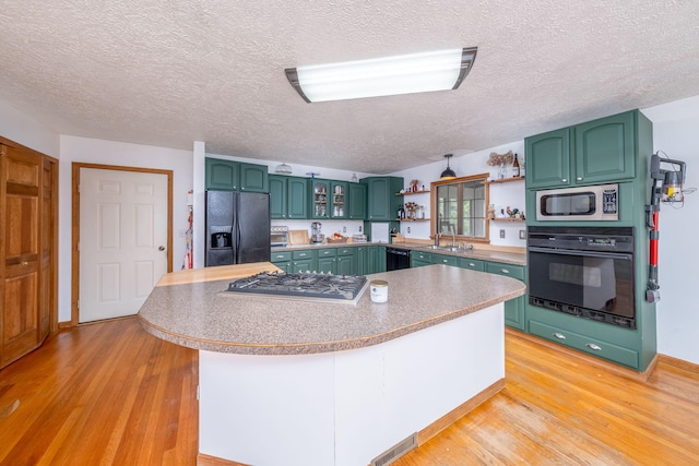 4300 Holton-Duck Lake Rd, Twin Lake, MI 49457 - kitchen with black appliances, a sink, open shelves, a textured ceiling, and green cabinets