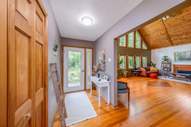 4300 Holton-Duck Lake Rd, Twin Lake, MI 49457 - foyer entrance featuring light wood-type flooring, vaulted ceiling, and baseboards