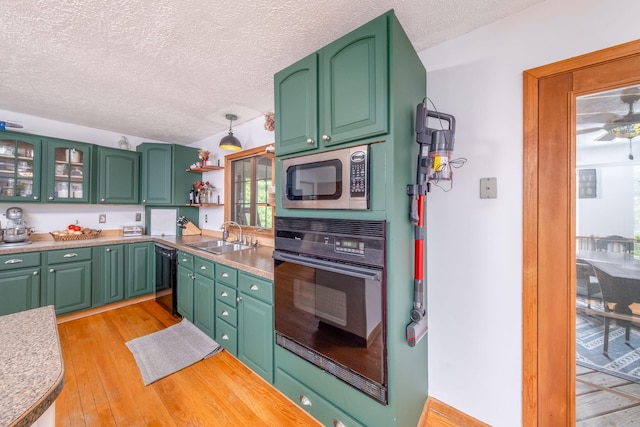 4300 Holton-Duck Lake Rd, Twin Lake, MI 49457 - kitchen with black appliances, a sink, a textured ceiling, light wood-type flooring, and light countertops