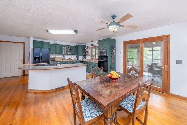 4300 Holton-Duck Lake Rd, Twin Lake, MI 49457 - dining area featuring light wood-type flooring, a textured ceiling, ceiling fan, and baseboards