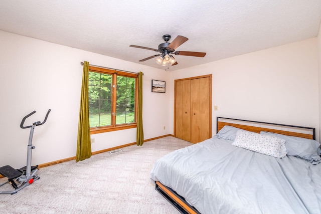 4300 Holton-Duck Lake Rd, Twin Lake, MI 49457 - carpeted bedroom featuring baseboards, a textured ceiling, a ceiling fan, and a closet