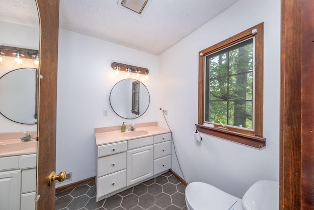 4300 Holton-Duck Lake Rd, Twin Lake, MI 49457 - bathroom featuring vanity, toilet, baseboards, tile patterned floors, and a textured ceiling