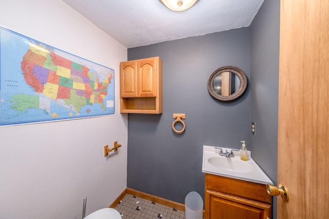 4300 Holton-Duck Lake Rd, Twin Lake, MI 49457 - half bath featuring tile patterned floors, vanity, toilet, and baseboards