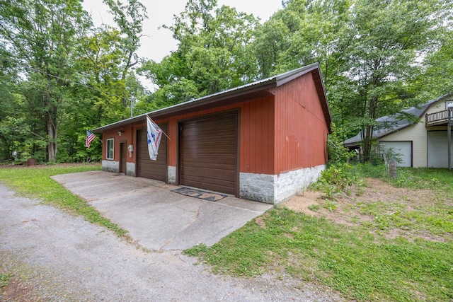 4300 Holton-Duck Lake Rd, Twin Lake, MI 49457 - view of front of property featuring a garage, an outdoor structure, and metal roof