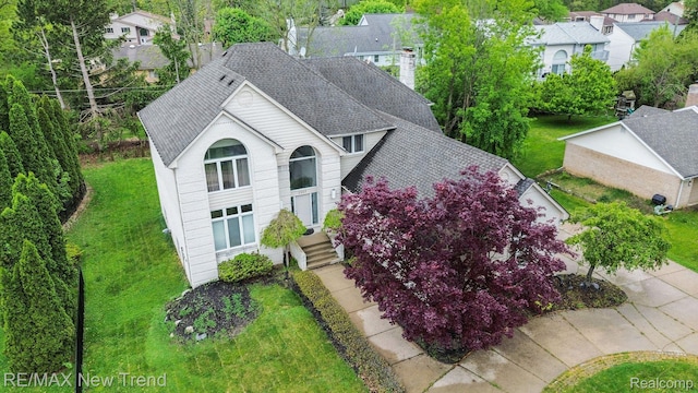 2337 Horseshoe Dr, West Bloomfield, MI 48322 - view of front of home featuring a shingled roof, a residential view, a chimney, and a front yard