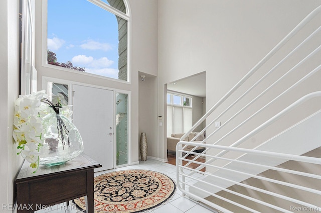 2337 Horseshoe Dr, West Bloomfield, MI 48322 - foyer entrance featuring tile patterned floors, a towering ceiling, and stairs