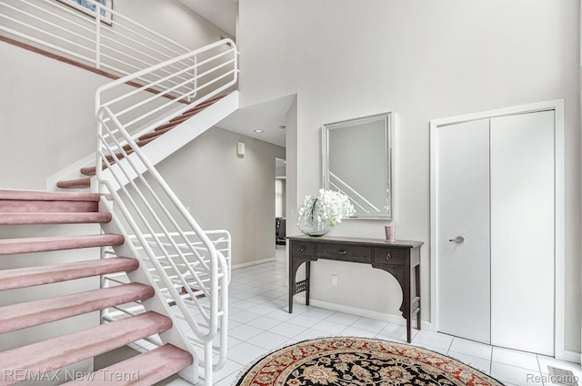 2337 Horseshoe Dr, West Bloomfield, MI 48322 - staircase featuring a high ceiling, tile patterned flooring, and baseboards