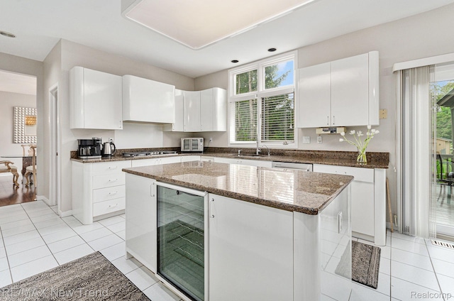 2337 Horseshoe Dr, West Bloomfield, MI 48322 - kitchen with wine cooler, plenty of natural light, white cabinetry, and recessed lighting
