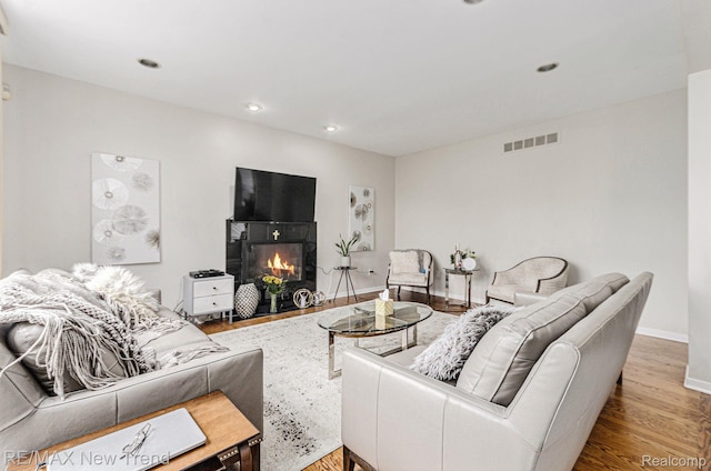 2337 Horseshoe Dr, West Bloomfield, MI 48322 - living area featuring wood finished floors, baseboards, a tiled fireplace, and recessed lighting