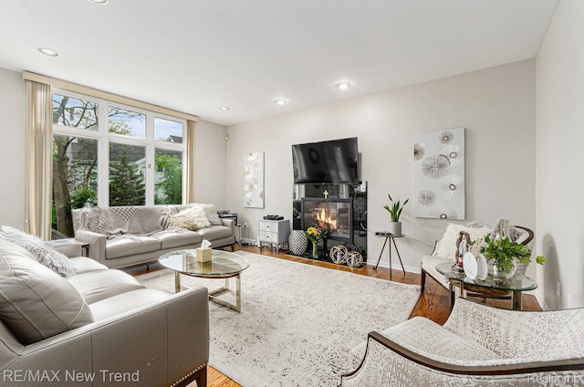 2337 Horseshoe Dr, West Bloomfield, MI 48322 - living room with wood finished floors, a fireplace with flush hearth, recessed lighting, and baseboards
