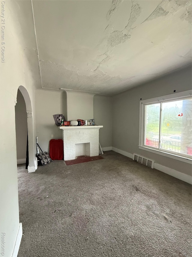 11647 Cascade St, Detroit, MI 48204 - unfurnished living room featuring arched walkways, carpet floors, and baseboards