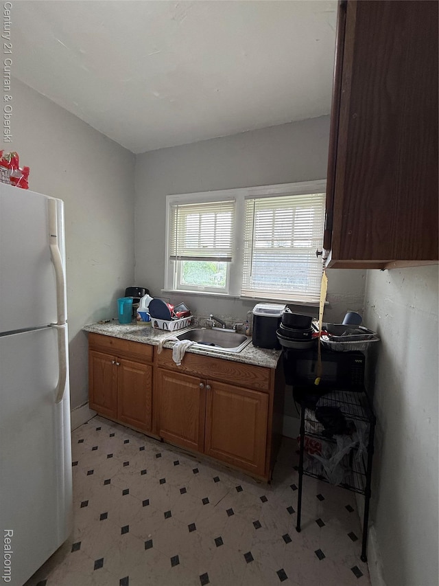 11647 Cascade St, Detroit, MI 48204 - kitchen featuring freestanding refrigerator, light floors, a sink, and light countertops