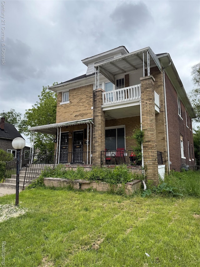 11647 Cascade St, Detroit, MI 48204 - view of front of home with a balcony, brick siding, a front lawn, and a porch