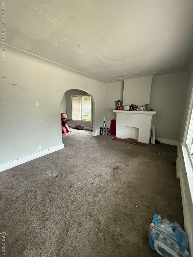 11647 Cascade St, Detroit, MI 48204 - unfurnished living room with arched walkways, carpet floors, and baseboards
