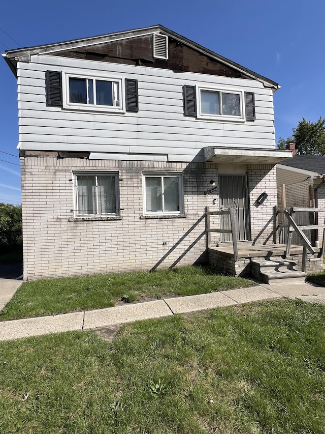 13990 Lauder St, Detroit, MI 48227 - view of front facade featuring brick siding and a front lawn