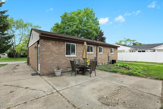 9939 Hamilton St, Michigan, MI 48111 - rear view of property with brick siding, a patio area, central AC, and outdoor dining space