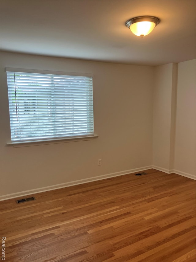 20747 Washington Dr, Roseville, MI 48066 - empty room with wood finished floors and baseboards