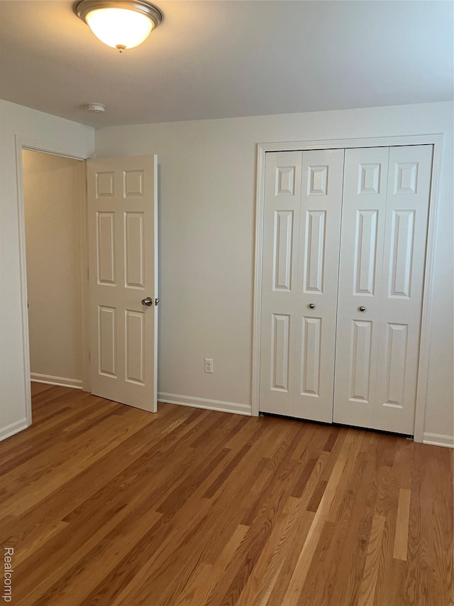 20747 Washington Dr, Roseville, MI 48066 - unfurnished bedroom with light wood-type flooring, a closet, and baseboards