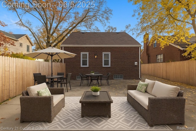 16509 Woodingham Dr, Detroit, MI 48221 - back of property featuring an outdoor hangout area, outdoor dining area, a fenced backyard, a patio, and brick siding