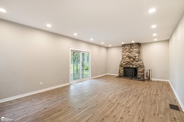 10207 Frances Rd, Flushing, MI 48433 - unfurnished living room with light wood-type flooring, recessed lighting, baseboards, and a fireplace