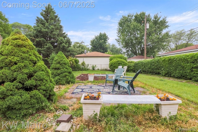 13443 Hartlein Dr, Warren, MI 48088 - view of green lawn with an outdoor fire pit and a patio