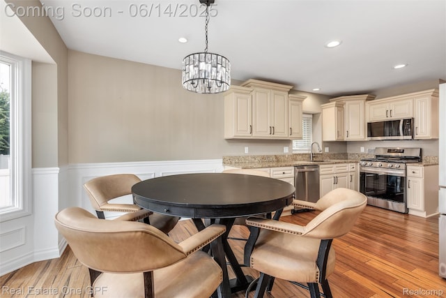 52657 Creekside Dr, Chesterfield, MI 48047 - dining space with a chandelier, a wainscoted wall, light wood-style flooring, and recessed lighting