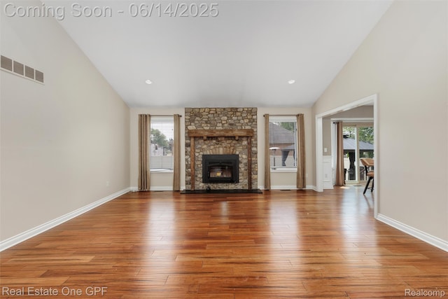 52657 Creekside Dr, Chesterfield, MI 48047 - unfurnished living room featuring vaulted ceiling, wood finished floors, and a fireplace
