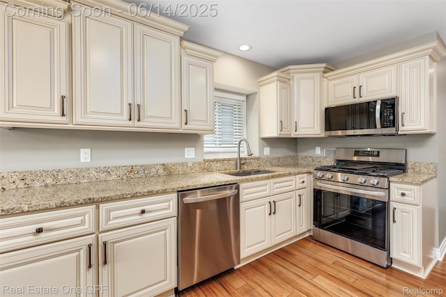 52657 Creekside Dr, Chesterfield, MI 48047 - kitchen featuring stainless steel appliances, light wood-type flooring, recessed lighting, light stone countertops, and cream cabinets