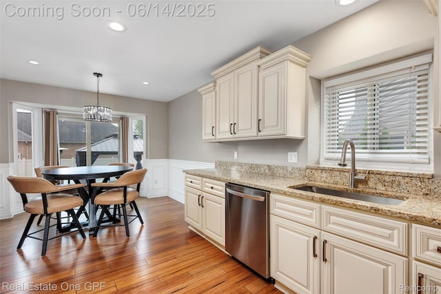 52657 Creekside Dr, Chesterfield, MI 48047 - kitchen with dishwasher, a wainscoted wall, a decorative wall, light wood-style flooring, and decorative light fixtures