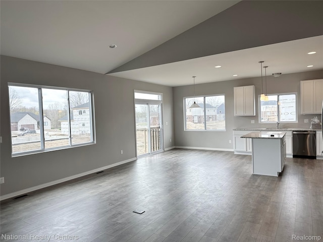 251 Devonshire Dr Unit 1, Lapeer, MI 48446 - kitchen featuring stainless steel dishwasher, a sink, a center island, white cabinetry, and open floor plan