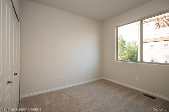 251 Devonshire Dr Unit 1, Lapeer, MI 48446 - unfurnished room featuring carpet flooring and baseboards