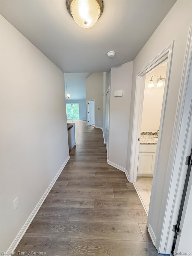 251 Devonshire Dr Unit 1, Lapeer, MI 48446 - hallway featuring wood finished floors and baseboards