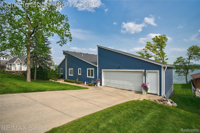 7457 Haviland Beach Dr, Argentine, MI 48451 - view of side of property featuring driveway, a garage, and a lawn