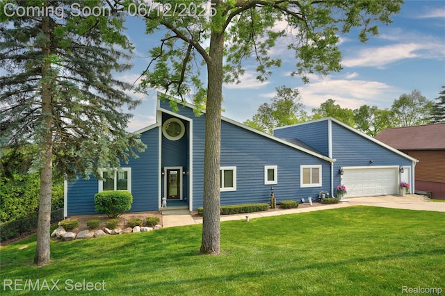 7457 Haviland Beach Dr, Argentine, MI 48451 - mid-century modern home with concrete driveway, an attached garage, and a front lawn