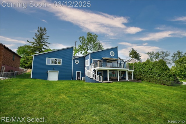7457 Haviland Beach Dr, Argentine, MI 48451 - back of property with a wooden deck, stairway, a patio area, and a garage