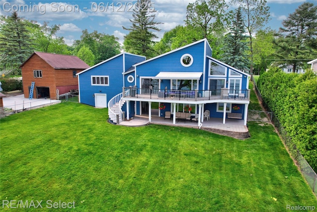 7457 Haviland Beach Dr, Argentine, MI 48451 - back of property with a wooden deck, a patio, stairs, a detached garage, and view of wooded area