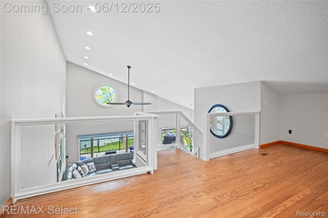 7457 Haviland Beach Dr, Argentine, MI 48451 - unfurnished living room with wood finished floors, recessed lighting, ceiling fan, a textured ceiling, and high vaulted ceiling