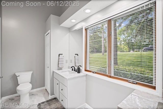 7457 Haviland Beach Dr, Argentine, MI 48451 - bathroom featuring marble finish floors, baseboards, vanity, toilet, and recessed lighting