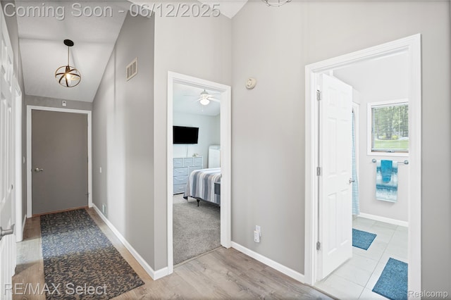 7457 Haviland Beach Dr, Argentine, MI 48451 - corridor featuring high vaulted ceiling, baseboards, and wood finished floors