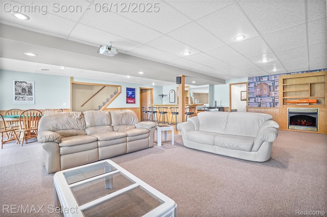 7457 Haviland Beach Dr, Argentine, MI 48451 - carpeted living room featuring a drop ceiling, stairway, recessed lighting, and bar area