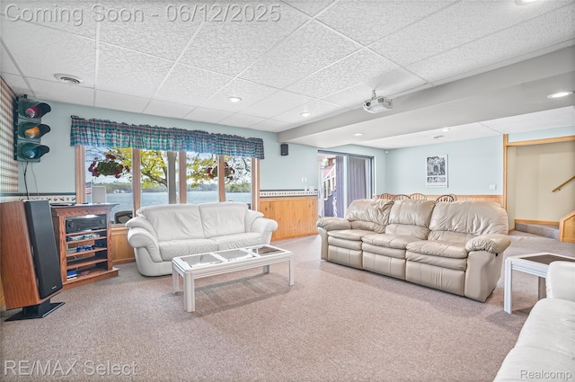 7457 Haviland Beach Dr, Argentine, MI 48451 - living area featuring a drop ceiling, carpet, wooden walls, and a wainscoted wall
