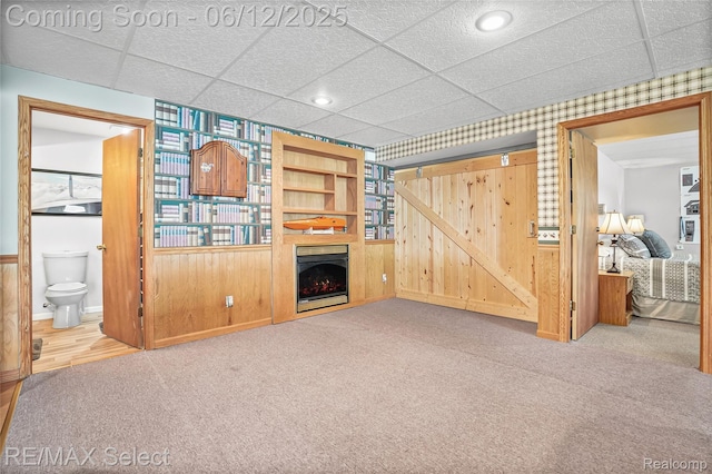 7457 Haviland Beach Dr, Argentine, MI 48451 - unfurnished living room with a drop ceiling, carpet, a fireplace, wallpapered walls, and baseboards