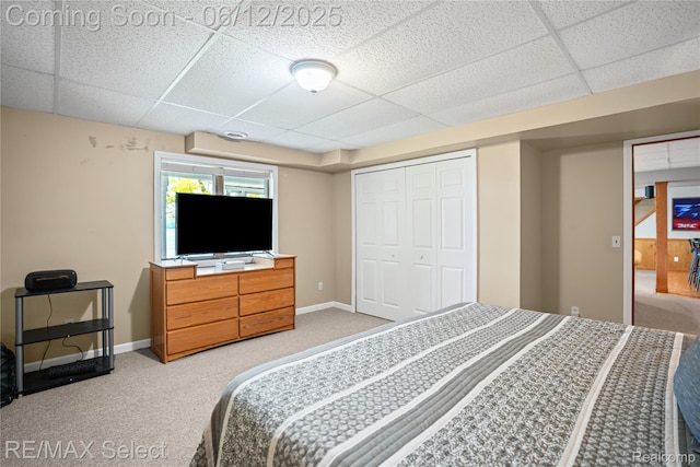 7457 Haviland Beach Dr, Argentine, MI 48451 - carpeted bedroom with a paneled ceiling, baseboards, and a closet